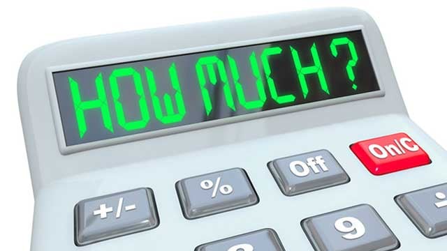 A plastic calculator showing the words How Much to figure.